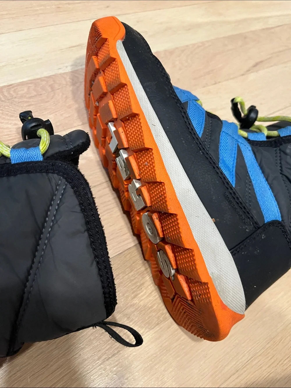 Sorel Kids Black Boots with Blue Stripes and Orange Sole